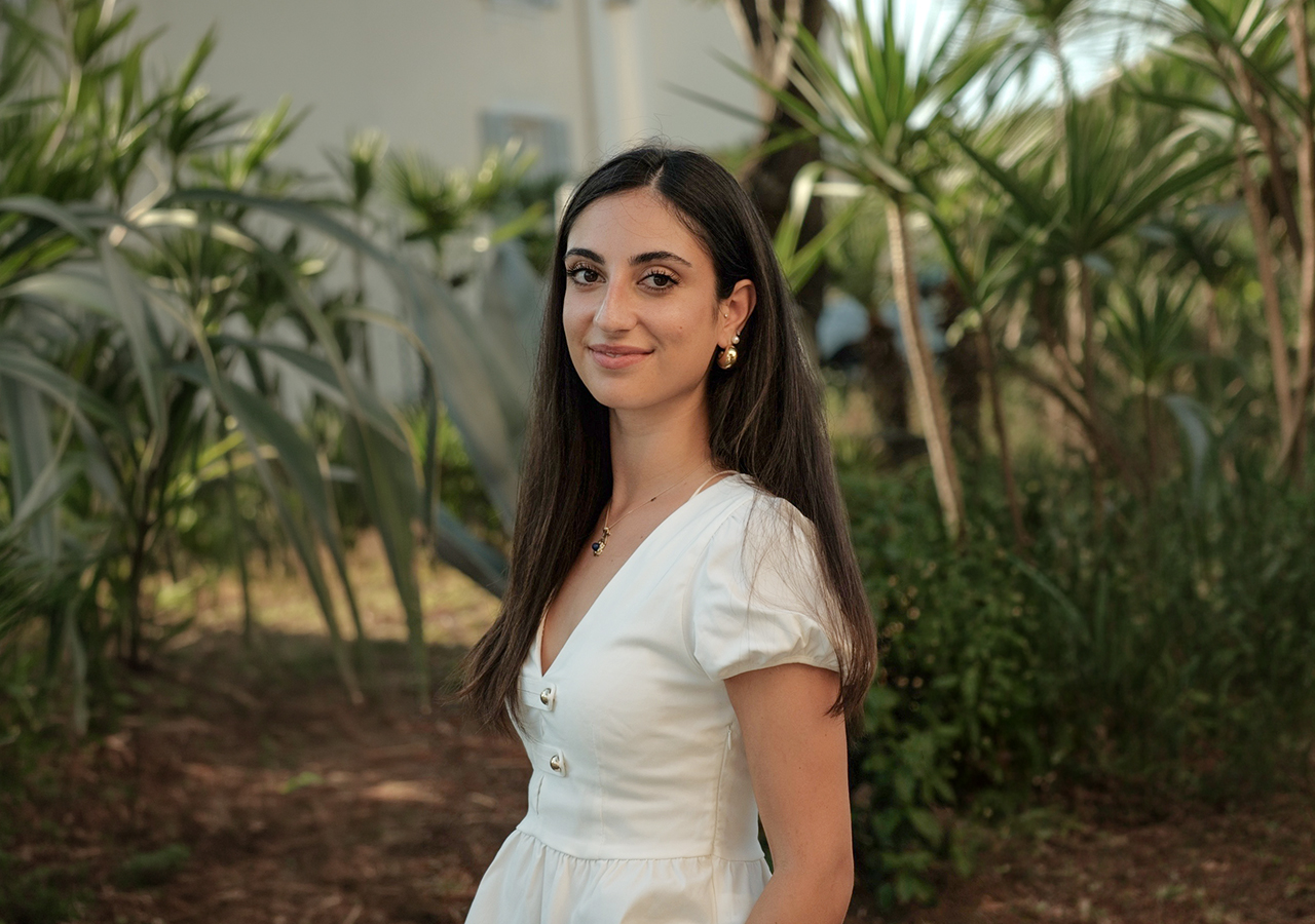 Denise Di Luigi, Charter Manager at Hill Robinson, photographed outdoors among Mediterranean greenery.